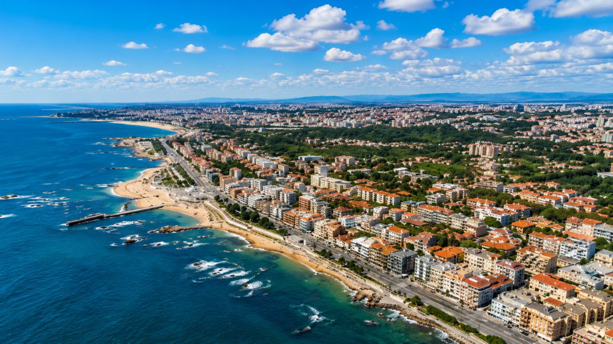 Vista aérea da orla marítima da Foz do Douro mostrando praias e edifícios residenciais de luxo no Porto