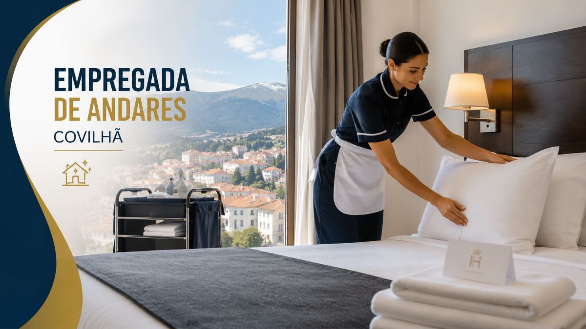 Empregada de andares na Covilhã a preparar a cama de um quarto de hotel moderno, com um carrinho de limpeza ao lado e vista panorâmica para a cidade e a serra.